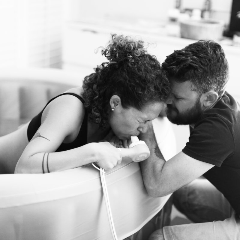 Woman in birthpool clearly in labour